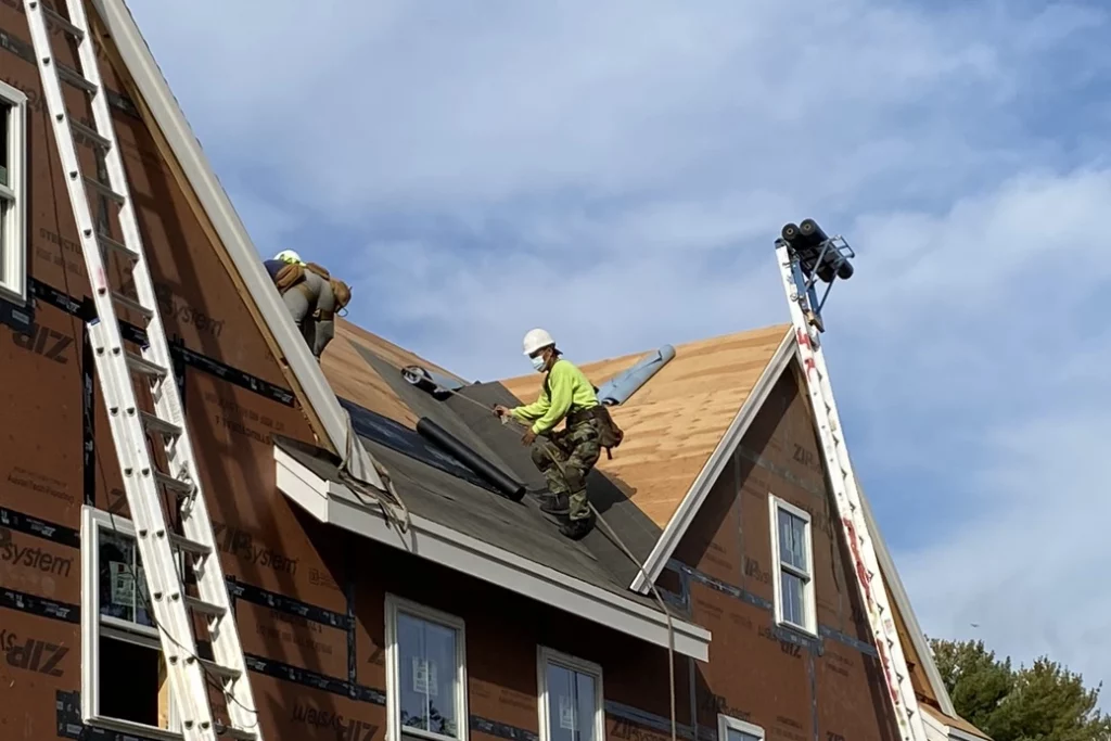 roofers installing tar paper